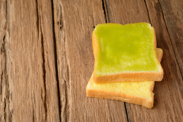 sliced thai custard bread on wood table