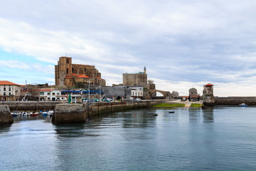 Fototapeta na wymiar Panoramic of Castro Urdiales, with the church of Santa Maria de la Asuncion and Castle Lighthouse in the background