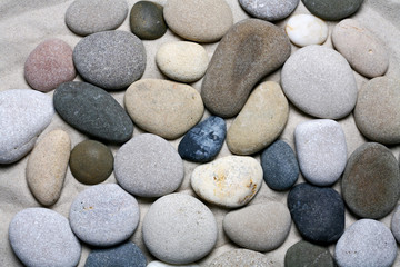 Fototapeta na wymiar Sea stones background, black and white pebble texture