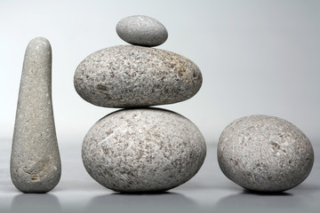 Fototapeta na wymiar Stack of stones - pebbles on grey background