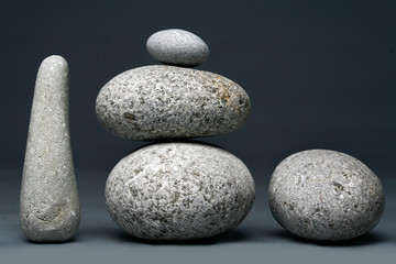 Fototapeta na wymiar Stack of stones - pebbles on dark grey background