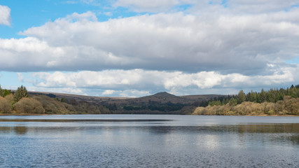 A landscape photograph of a resivior surrounded beautiful countryside located in Cornwall and Devon.