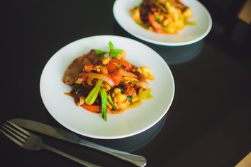 vegetables tomato, carrot, pepper,green beans on white plate