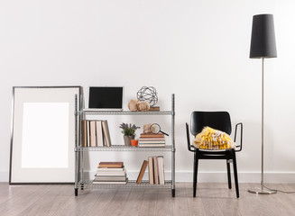 office work corner metal shelving with laptop black chair and frame behind white wall