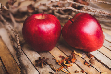 Fresh red two couple apple on brown rustic board