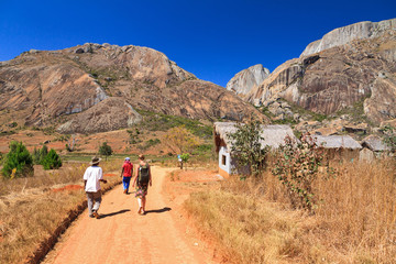 Tourist visiting Anja reserve national park in Madagascar on a beautiful day