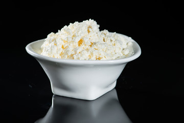 close-up curd in a cup on a dark background