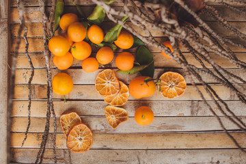 dried and fresh mandarin (tangerine)   wood board   rustic style