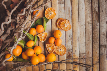 dried and fresh mandarin (tangerine)   wood board   rustic style