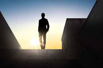 silhouette of businessman over sun light