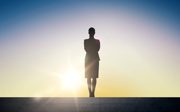 silhouette of business woman with over sun light