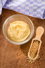 mustard seeds on a wooden shovel and mild mustard