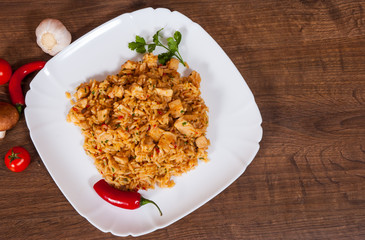 Rice with Vegetables and Meat in a plate on wooden table