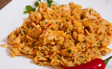 Rice with Vegetables and Meat in a plate on wooden table