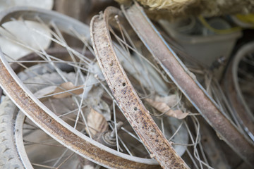 Many old rusty bicycle wheel.
