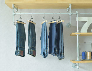 jeans hanging in industrial style walk in closet