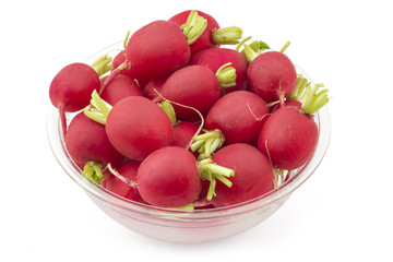 Raw organic small garden radishes in a bowl on white background