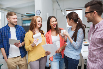 creative team on coffee break talking at office