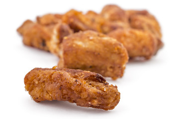 Heap of domestic salty fried pork greaves, cvarci, isolated on white, macro closeup
