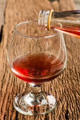 Viewed from the top red wine in a glass timber on the floor vint