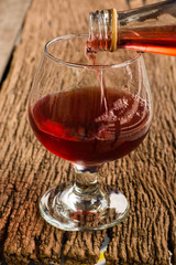 Viewed from the top red wine in a glass timber on the floor vint