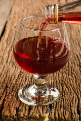 Viewed from the top red wine in a glass timber on the floor vint