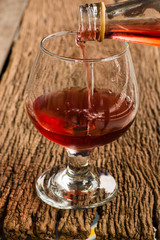 Viewed from the top red wine in a glass timber on the floor vint