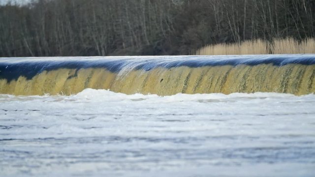 Slow motion shot of Vimba fish jumping up the Europe's widest waterfall Venta rapids in Kuldiga, Latvia during spring floods