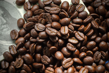 roasted coffee beans on money background.