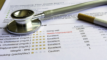 Cigarettes and stethoscope on lab test result
