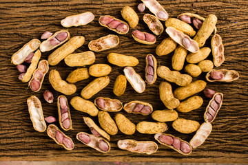 fresh ground nuts on old wooden background