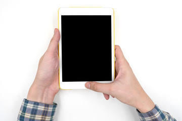 Male hands holding a white tablet touch computer gadget with touch blank black screen on white background.