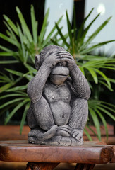 Fototapeta premium Monkey sculpture on wooden stick.