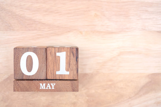 May 1st. Image of may 1 wooden color calendar on wood background. Empty space for text. International Workers' Day