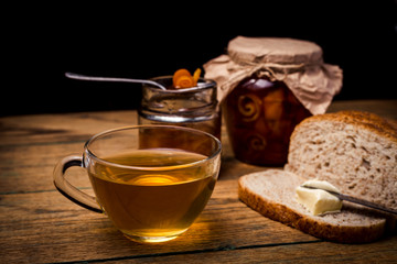 Homemade citrus orange jam on toast over wooden table