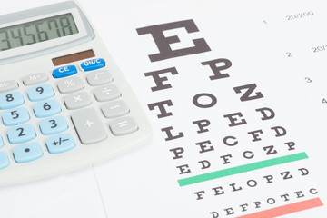 Table for eyesight test with calculator over it