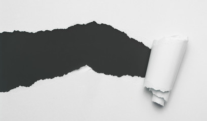 Torn white paper with black space