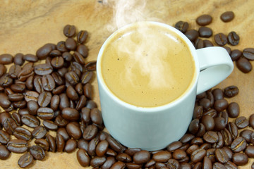 Coffee and coffee bean on wood background