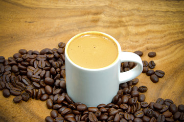 Coffee and coffee bean on wood background