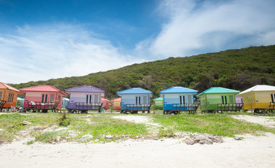 Fototapeta na wymiar Tropical style colorful bungalow and blue sky background.