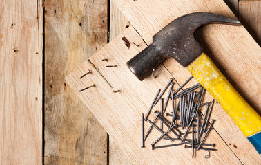 Hammer and tack on wood,Selective focus on tack,morning light