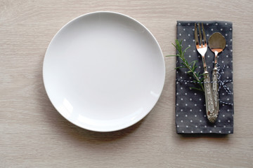 Shabby chic table setting with wooden background and vintage cutlery. Top view with copy space