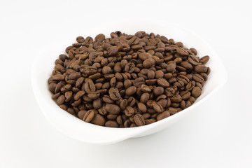 white plate full of coffee beans