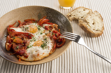 Turkish spiced Menemen eggs with onions peppers, chilli & tomato 
