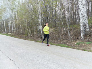 Fototapeta premium Young woman running in nature.