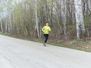 Young woman running in nature.