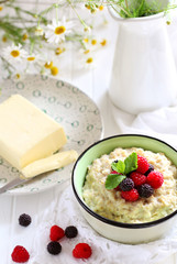 Breakfast with porridge with berries and butter