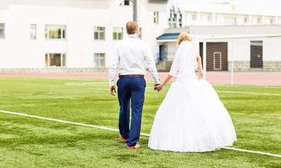 Fototapeta na wymiar European Football Championship concept. Wedding couple on the football stadium.