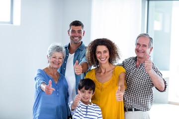 Portrait of happy family showing their thumbs up