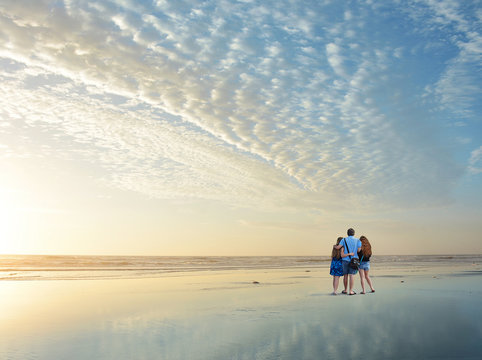 Family Enjoying Time Together On Beautiful Beach At Sunrise., Jacksonville, Florida, USA. 